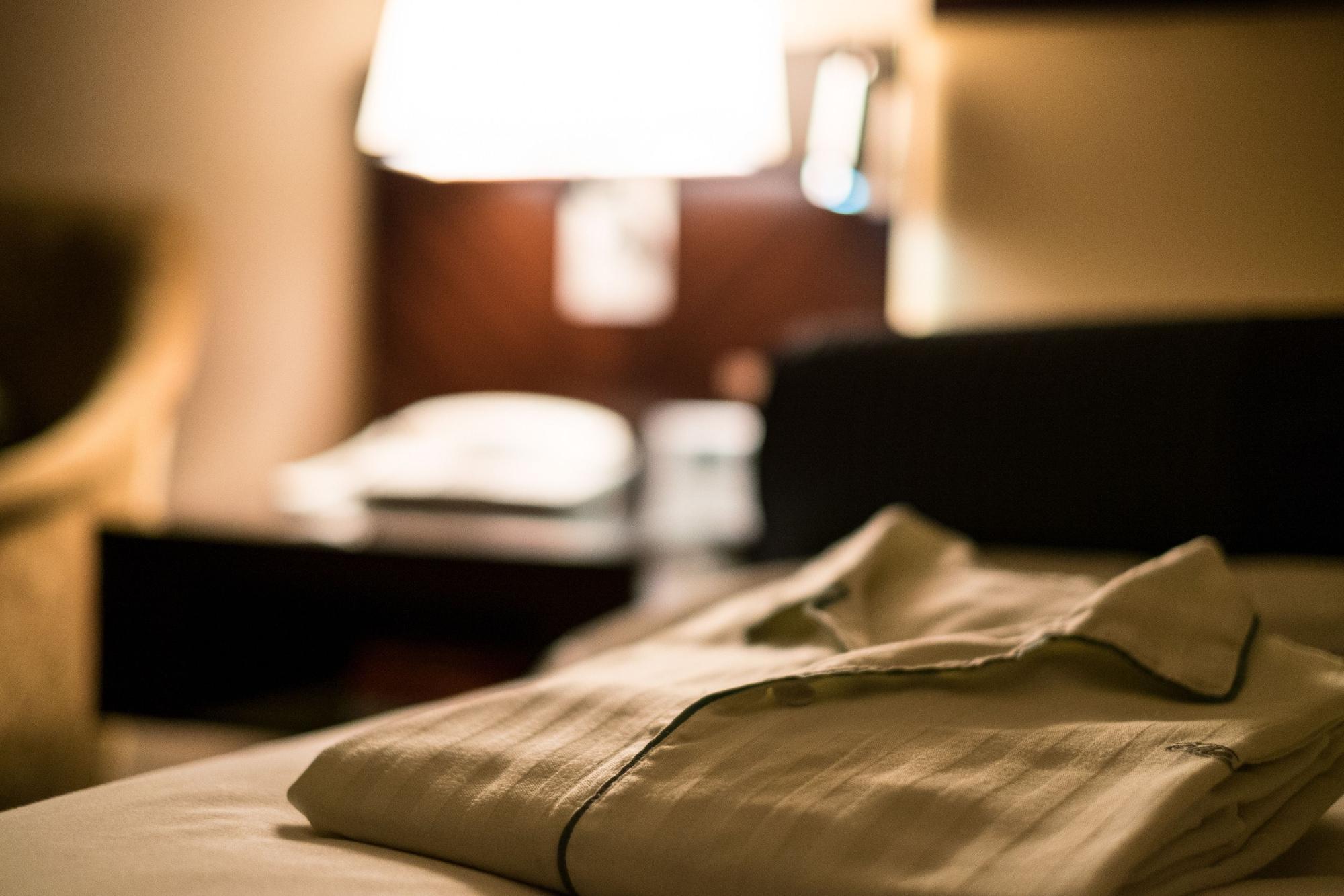 Hotel New Otani Hakata Fukuoka  Zewnętrze zdjęcie A shirt left on a bed